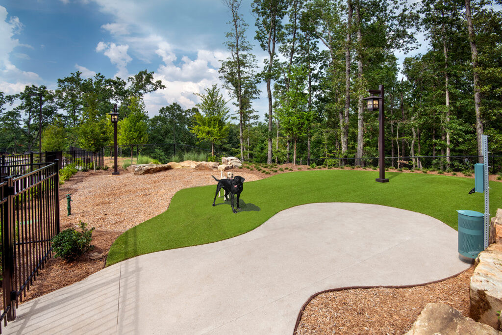 Luxury Apartments for Rent in Raleigh, NC - Town Triangle Crossing - Spacious Fenced-in Dog Park with Grass, Woodchips, and a Trash Can